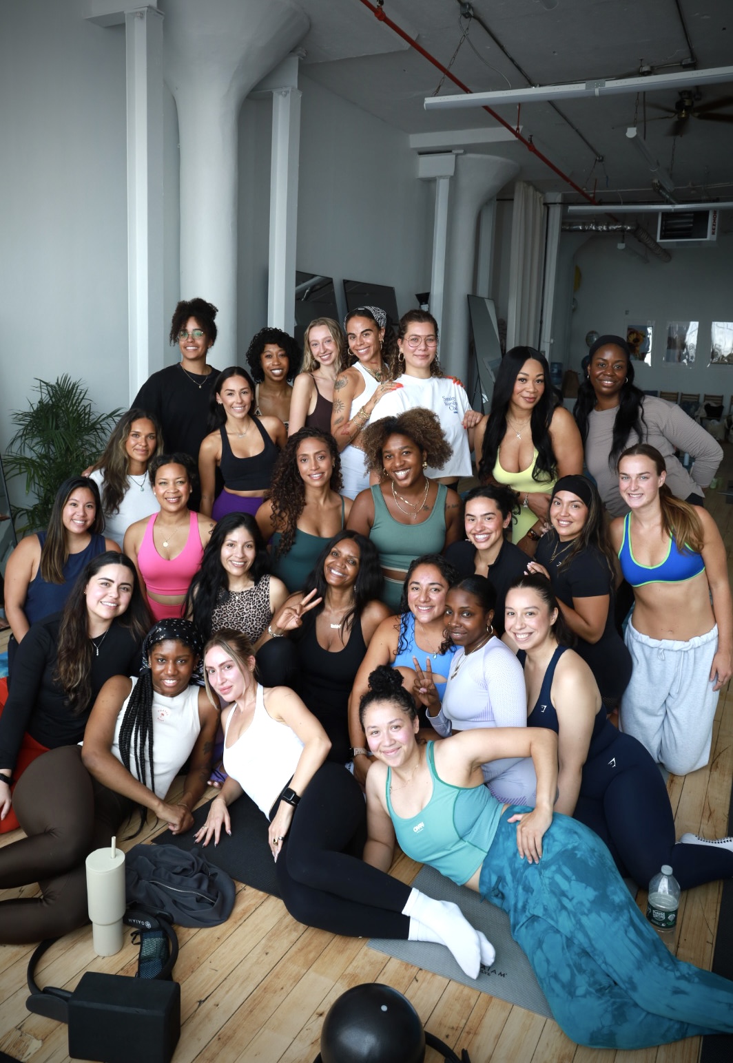 A Pilates Plug cohort standing together in the studio after a training day
